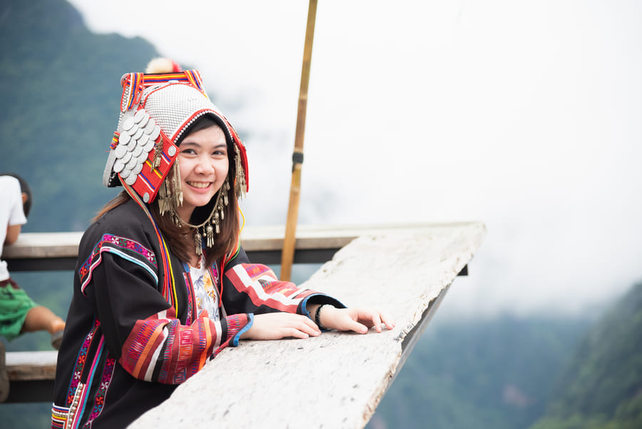Mujer sonriente posando desde un mirador en Yunnan